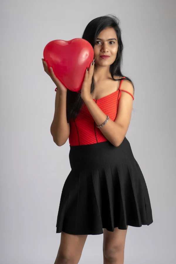 cheerful-cute-girl-fancy-red-black-outfit-posing-with-heart-shape-balloon_converted